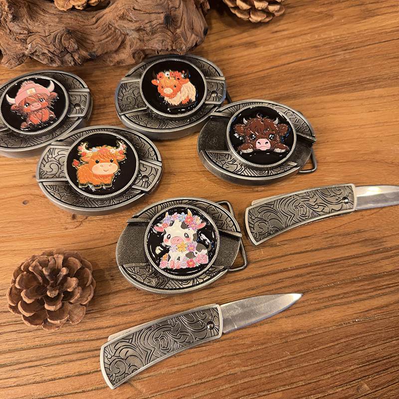 Close-up of glossy enamel highland cow belt buckle with western engraved details